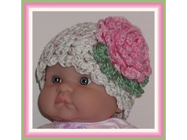 Cream baby girls hat with a pink flower