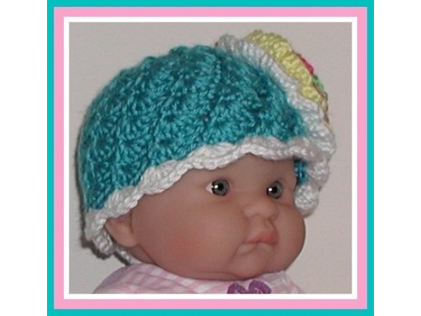 Turquoise baby girl hat with big pink yellow flower