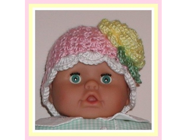 Pink baby hat with a yellow flower