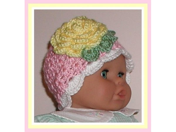 Pink baby girls hat with a yellow flower