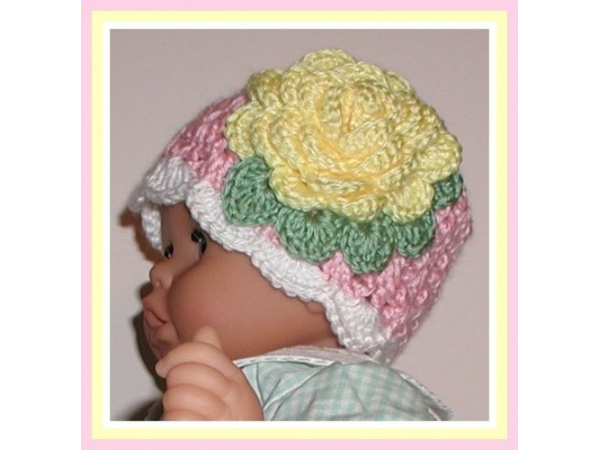 Pink and white hat for baby girls with a yellow flower