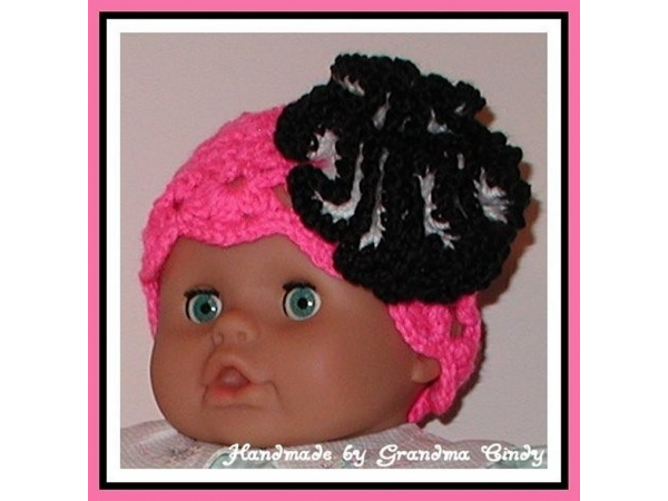 Neon pink hat for baby girls with black and white flower