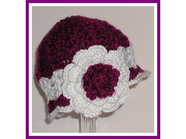 Baby girls hat in purple and white