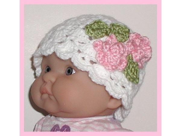 white newborn hat with pink flowers
