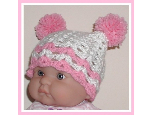 white baby girl hat with pink pom poms