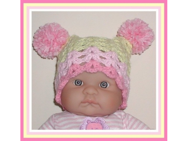 yellow and pink newborn girls hat with pom poms