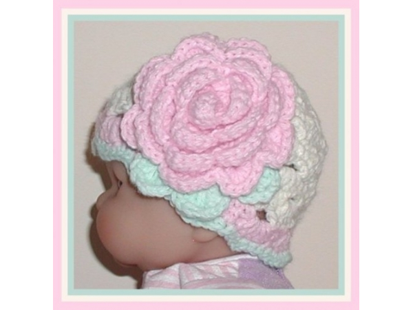 cream and pink newborn girls hat with a flower