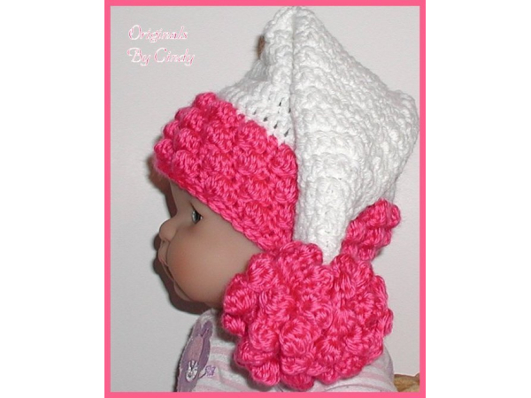 White and dark hot pink baby girls hat with a long tail and ruffled flower