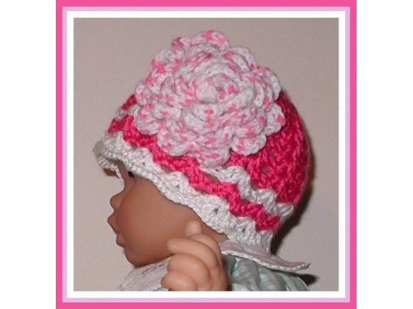 dark pink baby girls hat with a big pink and white flower