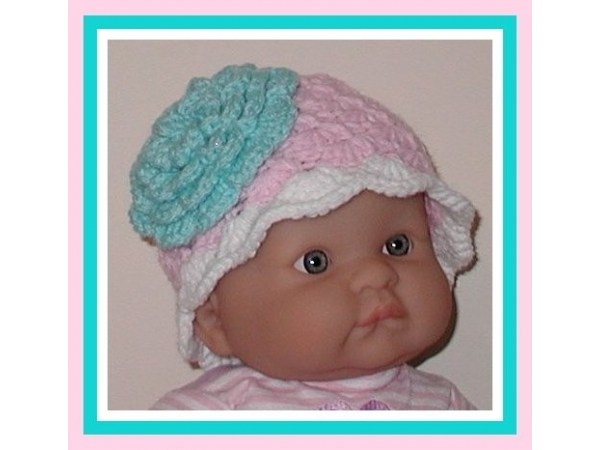 pink and white hat for newborn girls with a big aqua blue flower