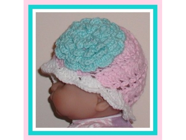 Pink and white newborn girl hat with large aqua blue flower