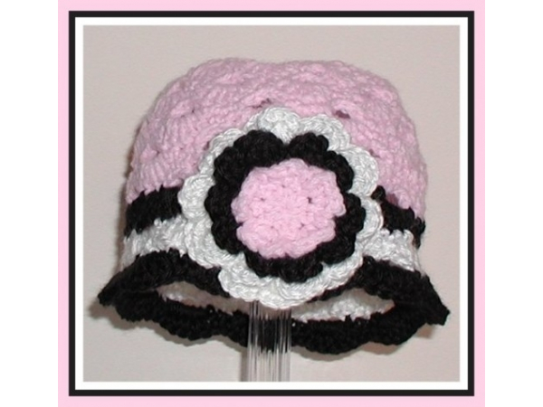 baby girls hat in pink black white with a flower