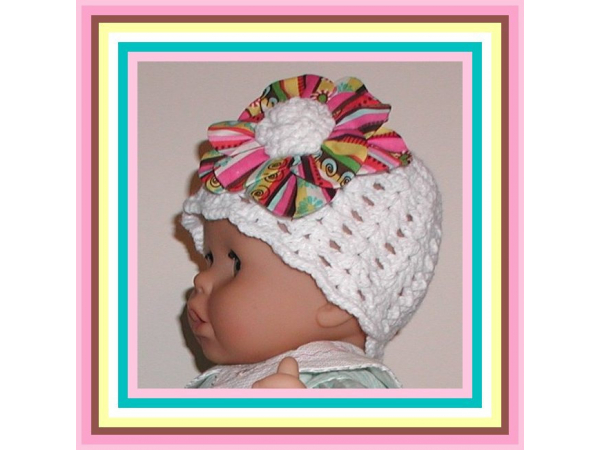 white hat for baby girls with a big multi colored flower