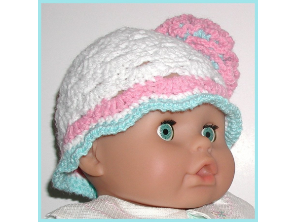White baby girls hat with aqua blue and pink flower