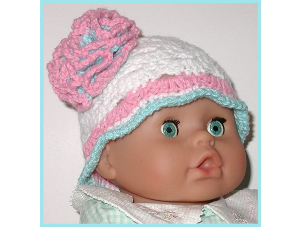 white baby girl hat with aqua and pink ruffle flower