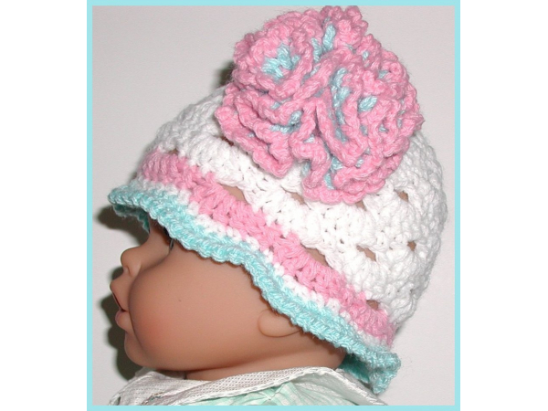 White baby hat with aqua blue and pink