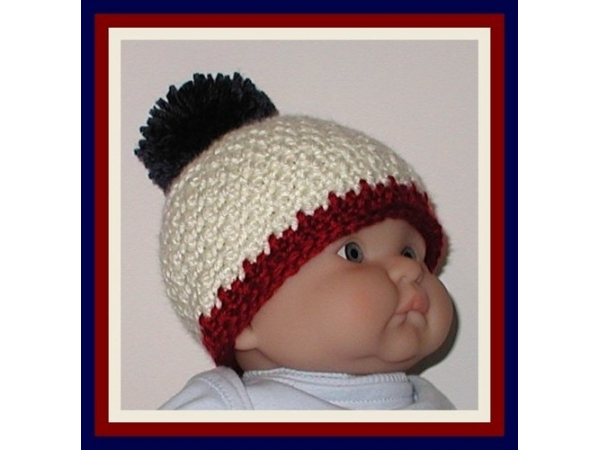 cream baby boys hat with navy blue pom pom
