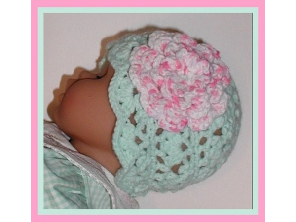 light pastel green baby hat with pink flower