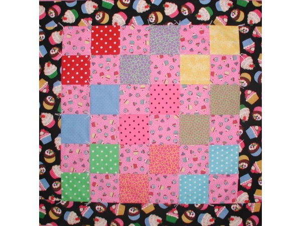 Baby girls quilt with cupcakes