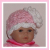 Pink and white preemie girls hat with a large flower