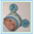 baby boys hat with blue and green pom poms