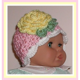 Pink baby girls hat with a yellow flower