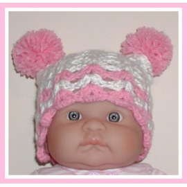 pink and white newborn hat with pom poms