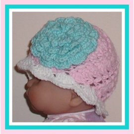 Pink and white newborn girl hat with large aqua blue flower